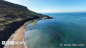 Man's body found on beach 'unexplained'