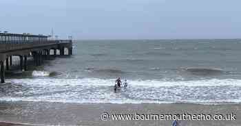 Family seen boogie boarding in sea during storm Darragh