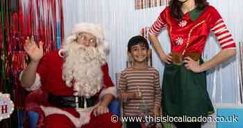 Santa and one of his elves visit hospital children's ward