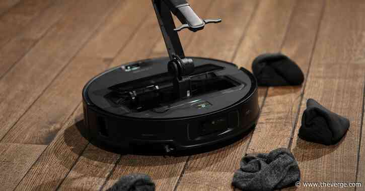 This robovac has an arm that can pick up your dirty laundry