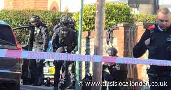 Armed police swarm busy road after incident in Carshalton