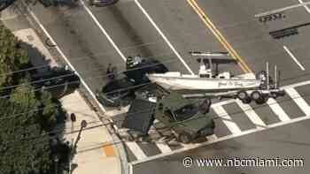 Rollover crash involving boat on trailer causes mess on Miami Shores roadway