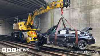 BMW driver under arrest in hospital after railway crash