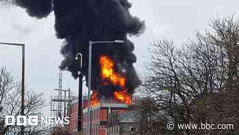 Fire crews tackle blaze at flats under construction