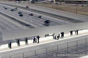 Demonstrators with Nazi flags leave Cincinnati-area highway overpass after residents confront them