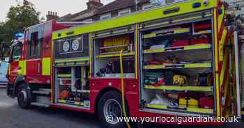Vans destroyed and building damaged by fire in Carshalton