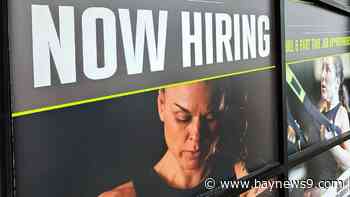 The number of Americans seeking jobless benefits falls as employers continue to hold on to workers