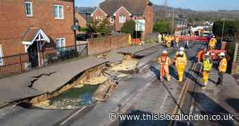 Homes evacuated as HUGE sinkhole opens in middle of Surrey high street