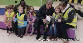 Nursery children brighten up rainy day with flowers for shoppers