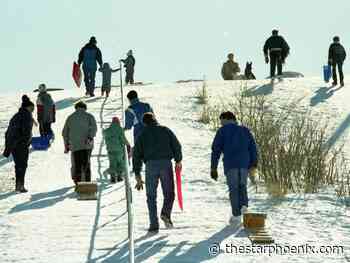 People slide down Saskatoon's Diefenbaker Hill in 1990