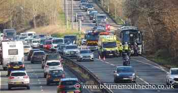 Driver taken to hospital and lane blocked after coach collides with central reservation