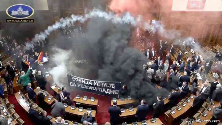 Serbian lawmakers throw smoke grenades, tear gas in parliament