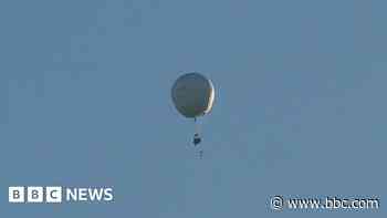 Why was a white balloon flying across the UK?