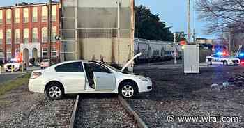 Freight train and car collide in downtown Durham