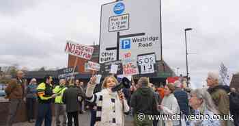 Hundreds of angry residents march to protest controversial bus gate
