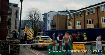 Major road cordoned off after man climbs lamppost in Colliers Wood