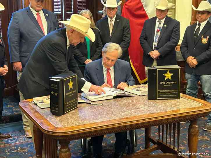 Man presents self-published book about Texas sheriffs to Gov. Abbott