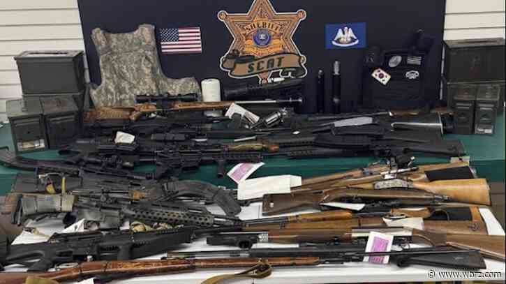 Drugs, 32 guns seized after five-hour standoff; alleged drug dealer found hiding in attic