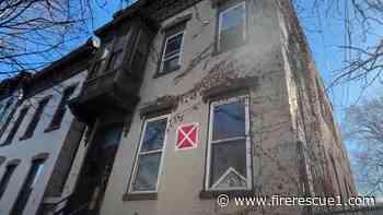 N.Y. firefighters take down 'X' signs as city restores abandoned buildings