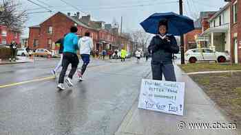 Thousands brave cold and rain to race new route in Around the Bay