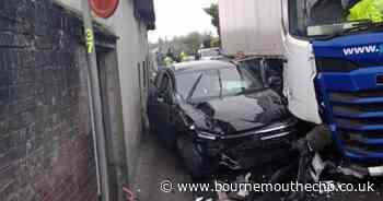 Person hospitalised after car crushed between wall and lorry