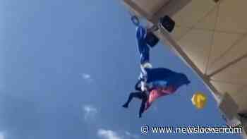 Parachutist bungelt aan dak Frans rugbystadion