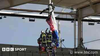 Sale game delayed as parachutist hangs from roof
