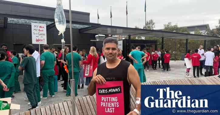 With a drip in his arm, this patient came out of a Sydney hospital to support striking doctors