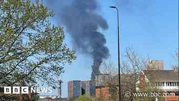 Plumes of smoke rise above city amid tyre blaze