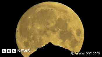 Photographer over the moon with lunar mountain shot