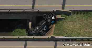 Truck flips onto edge of Little River in Durham County
