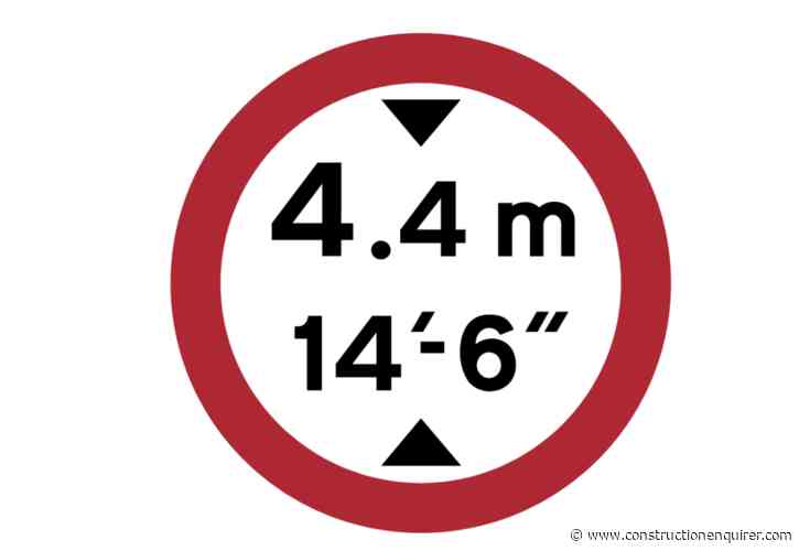 Excavator knocked off lorry going under bridge