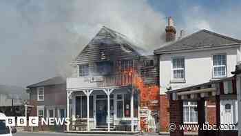 Sailing club fire put out after spreading to house