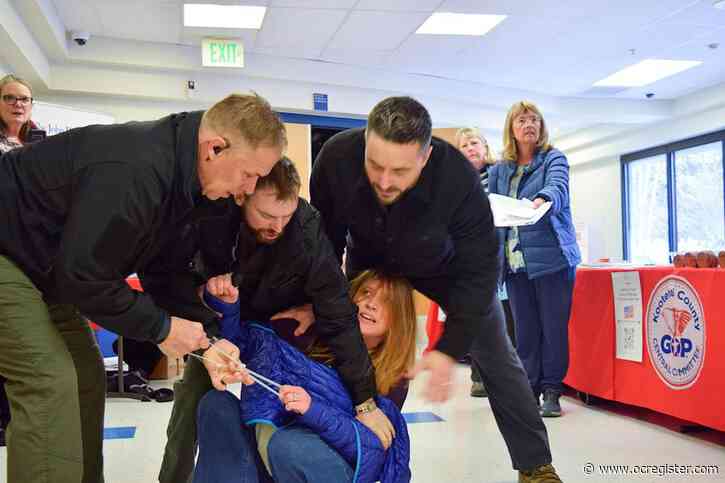 Private security guards charged after woman was dragged out of chaotic Idaho town hall meeting