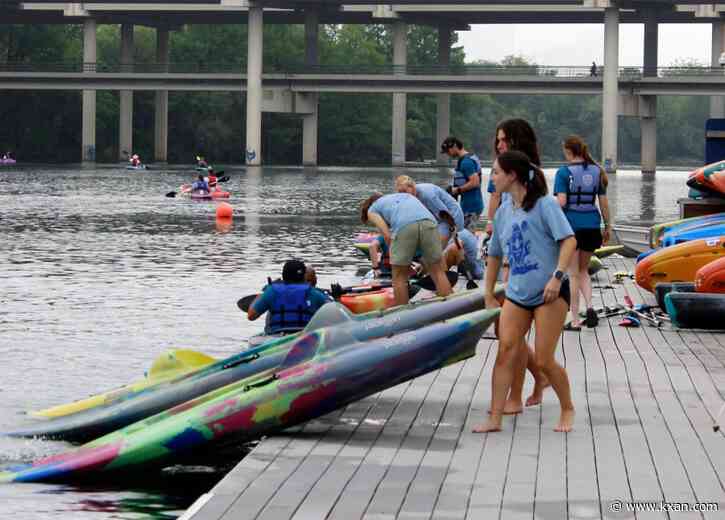 Volunteers sweep Lady Bird Lake for trash during annual cleanup