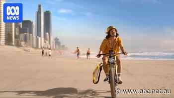 Qld government criticised for featuring e-bike on beach in tourism ad