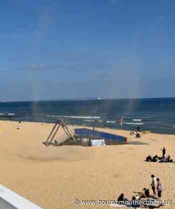 Video captures the moment a 'mini tornado' appears on beach