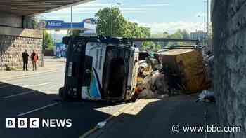 Overturned skip lorry causing delays in Belfast