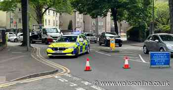 Major Cardiff road blocked after car overturns