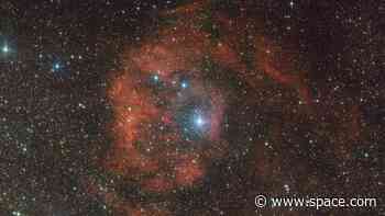 Cosmic imposter bathes distant nebula in fiery red glow: 'This star should not be here'