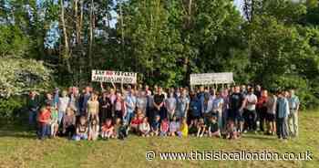 Large group of protesters gather against council plans to build homes