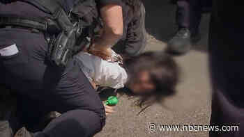 Massachusetts police hold girl's face to the ground as ICE arrests her mother, video shows