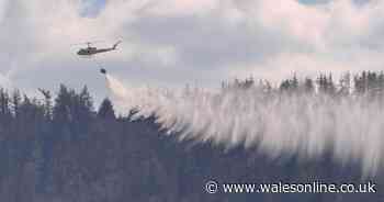 Helicopter brought in to help tackle huge wildfire as locals urged to stay indoors