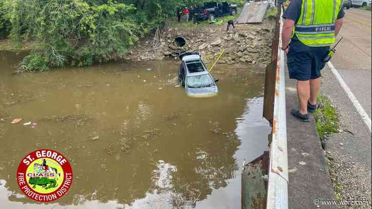 Divers help to pull submerged SUV from waterway