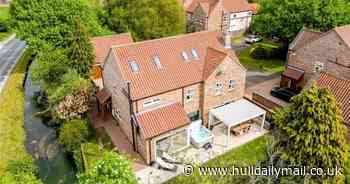 'Exceptional' house with water views and woodland garden