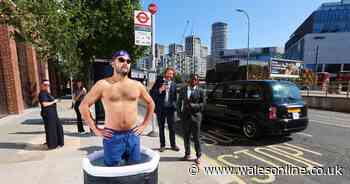 Bemused commuters spot man taking an ice bath outside a bus stop as balmy weather continues