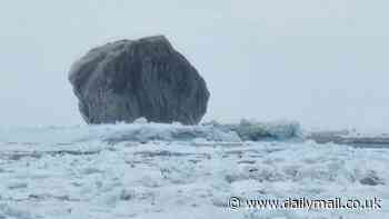 Fisherman is baffled after stumbling across a huge BLACK iceberg off the coast of Canada