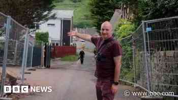 Residents celebrate as neighbour's gate is removed