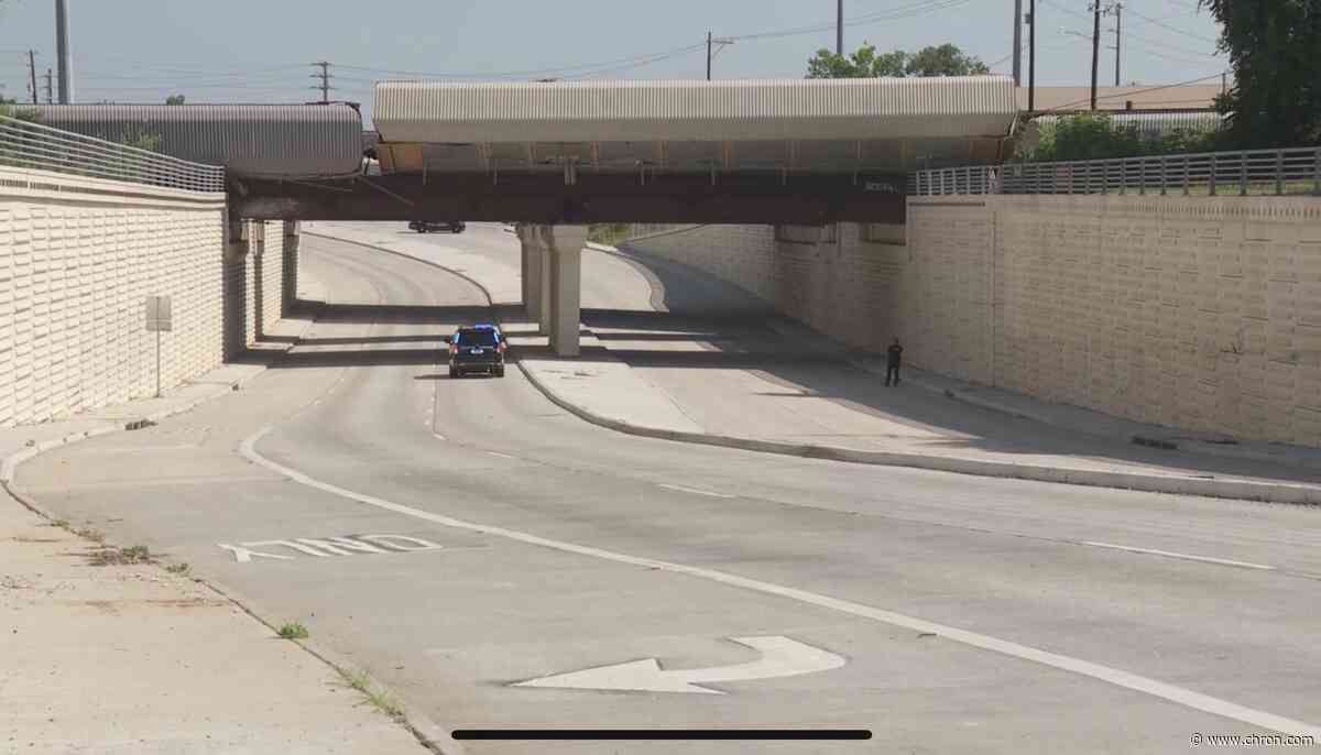 Nearly a dozen train cars seen dangling from Houston overpass after derailment