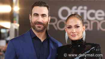 Jennifer Lopez dazzles in black sequins as she cosies up to co-star Brett Goldstein at the Office Romance premiere in London... after addressing dating rumours